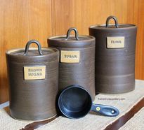 Three piece pottery canister set with plaques