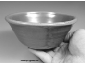 A small handmade pottery bowl in a hand