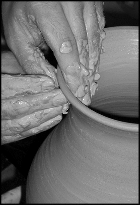 Tyler making a vase on the potter's wheel