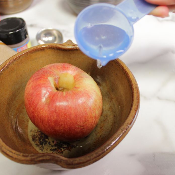 Handmade Pottery Apple Baker and apple adding water