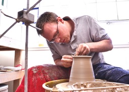 Tyler on the potter's wheel making a vase