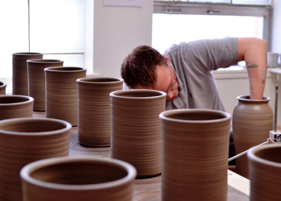 Tyler Sandstrom, Artist/Owner of From Miry Clay Pottery, creating on the potter's wheel